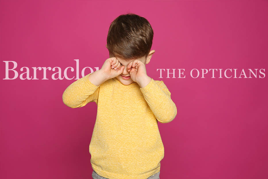 Boy rubbing his eyes